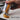 Hand squeezing legacy-label 676 Yellow Ochre onto board