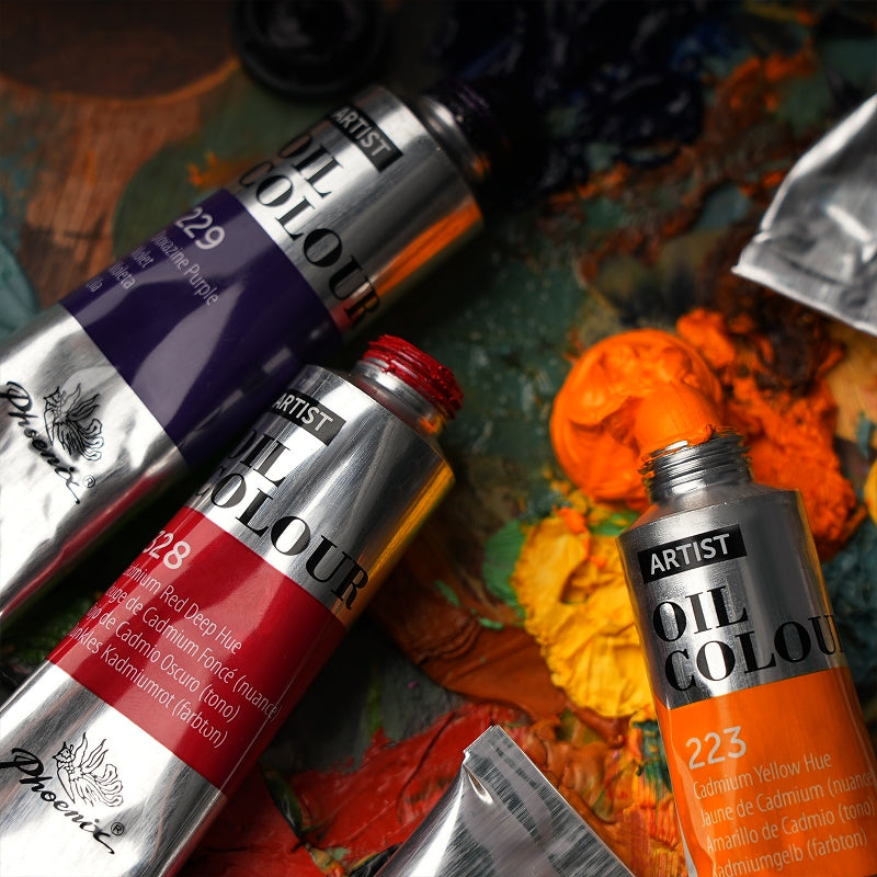 PHOENIX Artist Cadmium Yellow Hue 223 and Cadmium Red Deep Hue 328 tubes beside real paint on a palette.